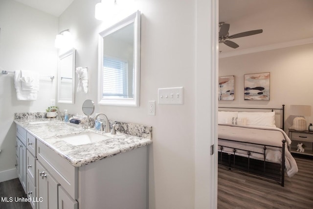 bathroom featuring vanity, ceiling fan, ornamental molding, and hardwood / wood-style floors