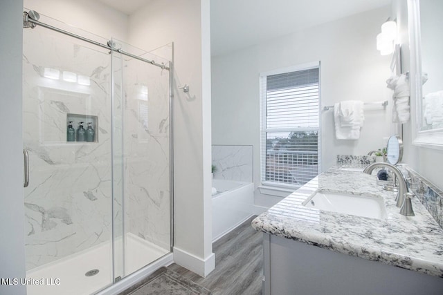 bathroom featuring vanity, shower with separate bathtub, and hardwood / wood-style flooring