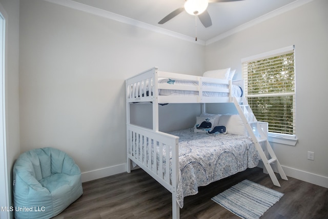 bedroom featuring dark hardwood / wood-style flooring, ornamental molding, and ceiling fan