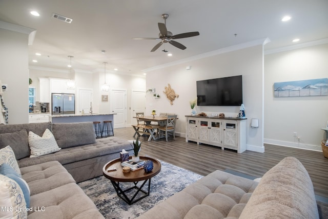 living room featuring ornamental molding, ceiling fan, and dark hardwood / wood-style flooring