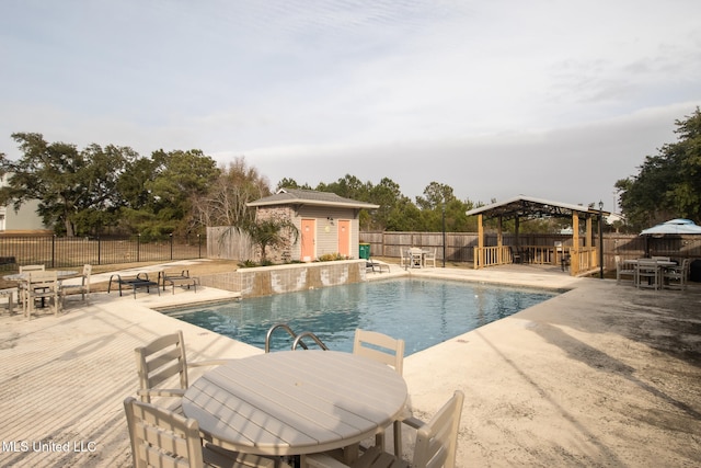 view of pool with a gazebo, a patio area, and a shed