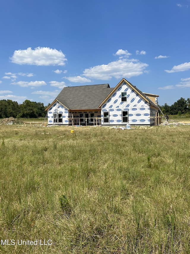 rear view of house with a rural view