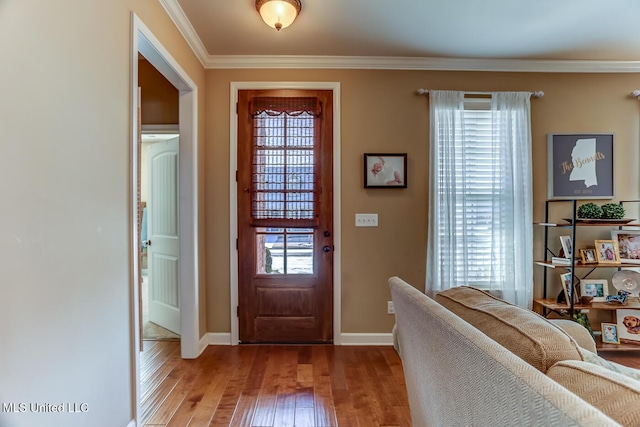 entryway featuring crown molding, plenty of natural light, and light hardwood / wood-style floors