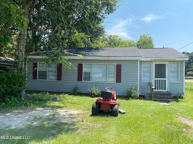 rear view of house featuring a lawn