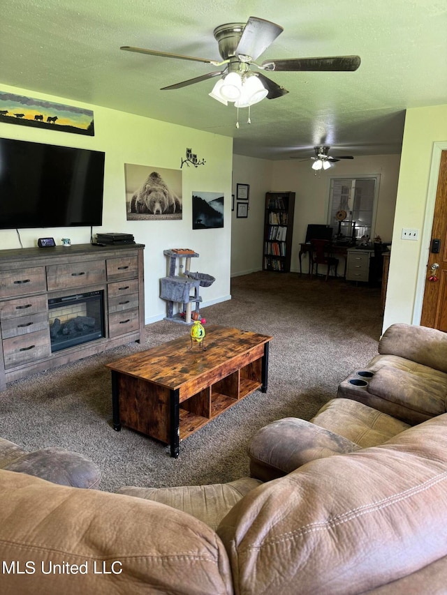 living room featuring ceiling fan, carpet flooring, and a textured ceiling