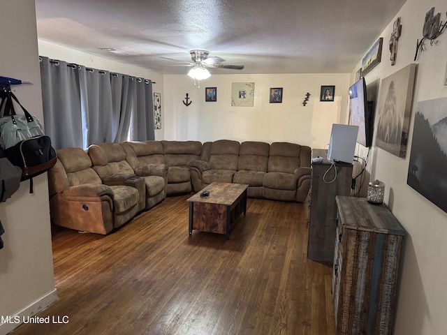 living room featuring ceiling fan and dark wood finished floors