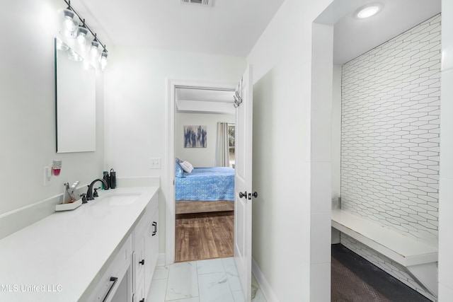 bathroom featuring a stall shower, visible vents, connected bathroom, marble finish floor, and vanity