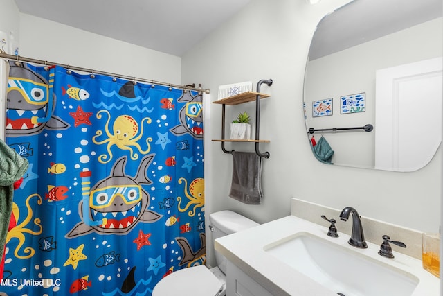 bathroom featuring toilet, curtained shower, and vanity