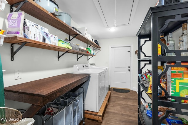 laundry room with laundry area, attic access, dark wood finished floors, and washing machine and clothes dryer