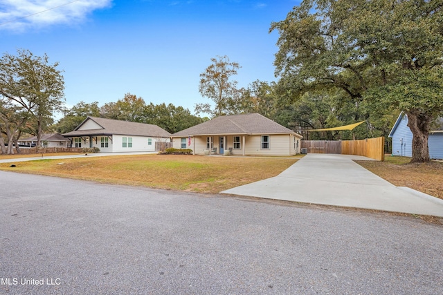 single story home with fence, driveway, and a front lawn