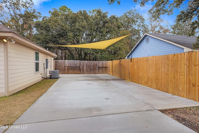 view of patio with a fenced backyard and central AC