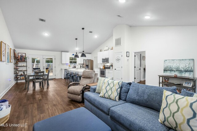 living room with high vaulted ceiling, visible vents, dark wood finished floors, and french doors