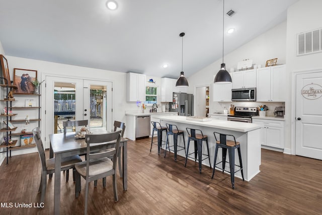 dining area featuring high vaulted ceiling, visible vents, dark wood-type flooring, and french doors