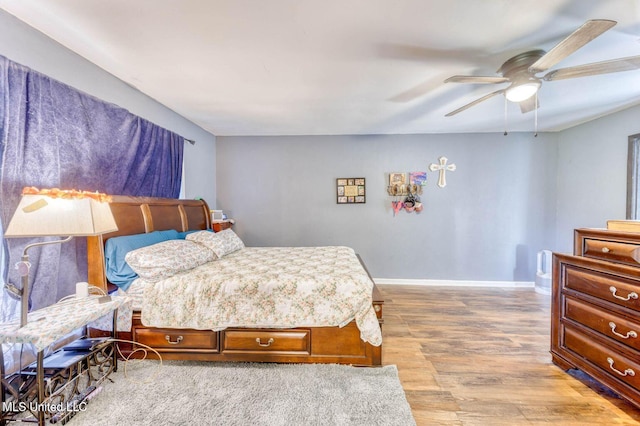 bedroom with hardwood / wood-style floors and ceiling fan