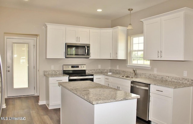 kitchen featuring appliances with stainless steel finishes, white cabinetry, and sink