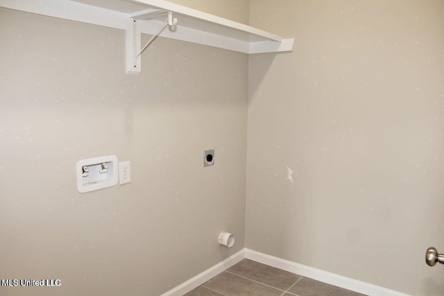 washroom featuring dark tile patterned flooring, hookup for a washing machine, and hookup for an electric dryer