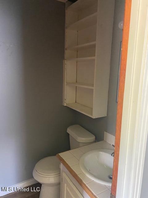 2804 Revere St, Jackson, MS 39212 - half bathroom with vanity, toilet, and baseboards