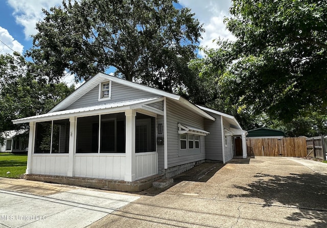 515 Krebs Ave, Pascagoula, MS 39567 - view of property exterior featuring a gate, a sunroom, and concrete driveway