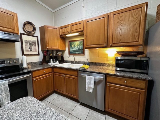 515 Krebs Ave, Pascagoula, MS 39567 - kitchen featuring stainless steel appliances, under cabinet range hood, ornamental molding, brown cabinetry, and light tile patterned floors