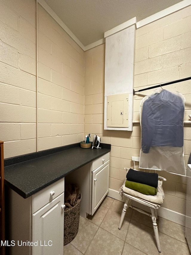 515 Krebs Ave, Pascagoula, MS 39567 - laundry room featuring concrete block wall, electric panel, light tile patterned floors, and ornamental molding
