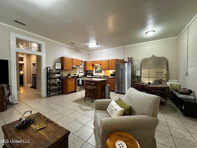 515 Krebs Ave, Pascagoula, MS 39567 - living room featuring crown molding, a textured ceiling, light tile patterned floors, and concrete block wall