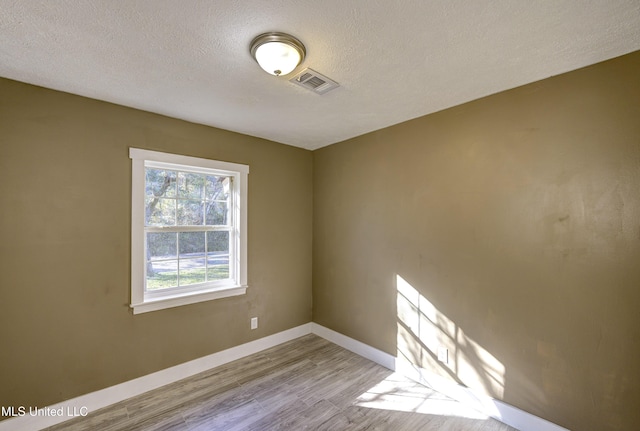 223 Second Ave, Vicksburg, MS 39183 - empty room featuring light hardwood / wood-style flooring and a textured ceiling