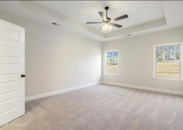 1716 Ryker Rd, Southaven, MS 38672 - empty room with a raised ceiling, light carpet, and a ceiling fan