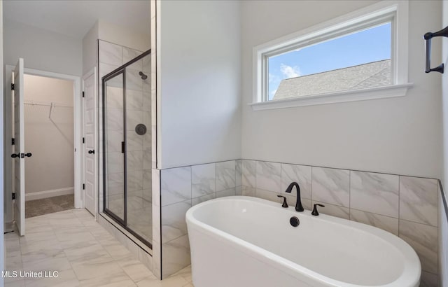 1716 Ryker Rd, Southaven, MS 38672 - bathroom with a freestanding bath, a stall shower, a walk in closet, and marble finish floors