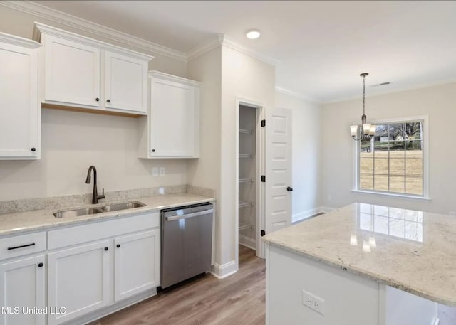 1716 Ryker Rd, Southaven, MS 38672 - kitchen with dishwasher, light wood-style floors, a chandelier, white cabinets, and ornamental molding