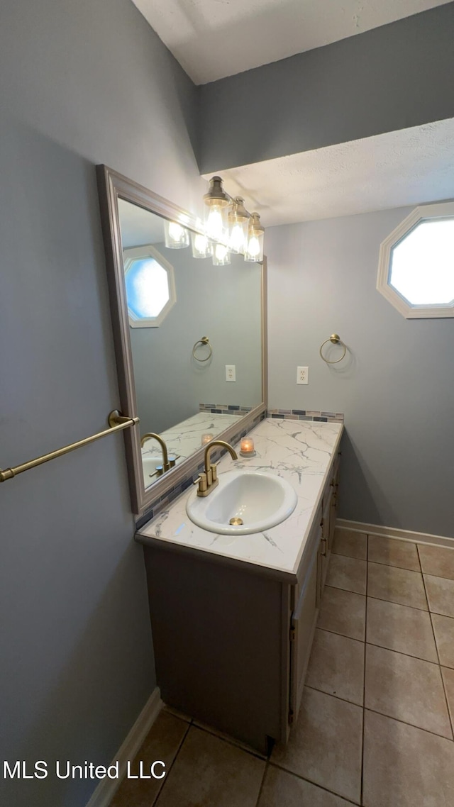 bathroom with tile patterned flooring and vanity