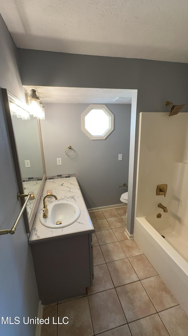 full bathroom with shower / washtub combination, vanity, a textured ceiling, tile patterned floors, and toilet