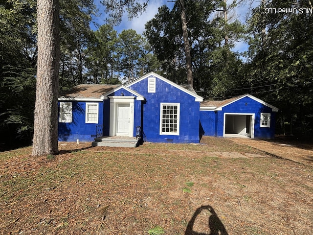 2123 Belvedere Dr, Jackson, MS 39204 - ranch-style home featuring concrete block siding, a detached garage, a front lawn, and an outdoor structure