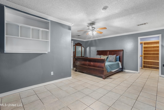 tiled bedroom featuring a textured ceiling, ceiling fan, and crown molding