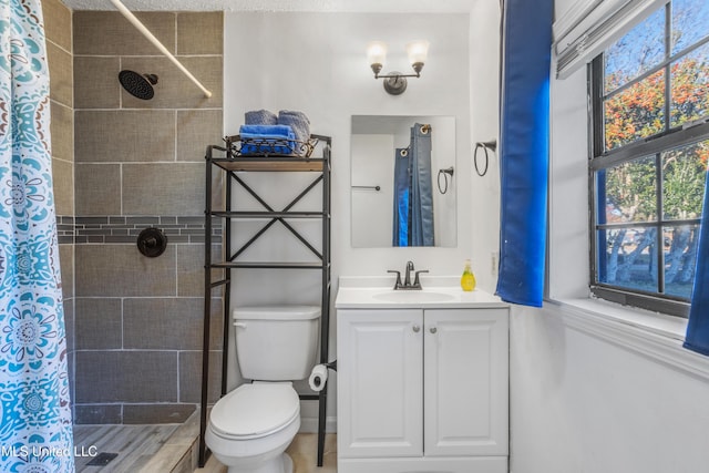 bathroom featuring curtained shower, vanity, hardwood / wood-style flooring, and toilet