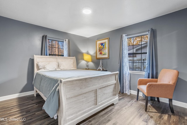 bedroom with dark wood-type flooring