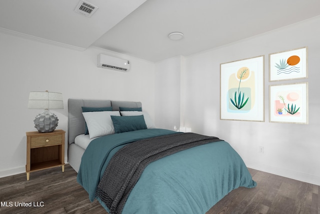 bedroom featuring dark hardwood / wood-style floors, ornamental molding, and a wall unit AC