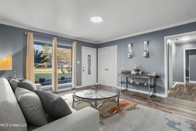 living room with hardwood / wood-style floors and crown molding