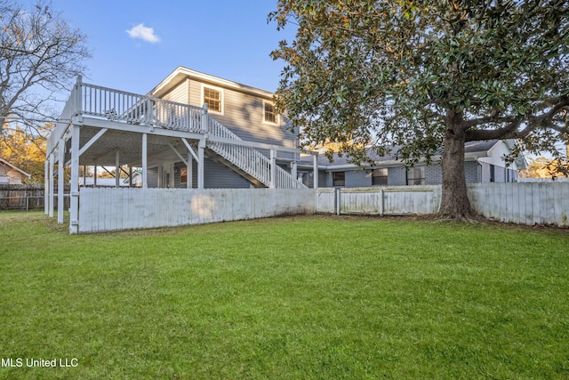 back of property featuring a yard and a deck