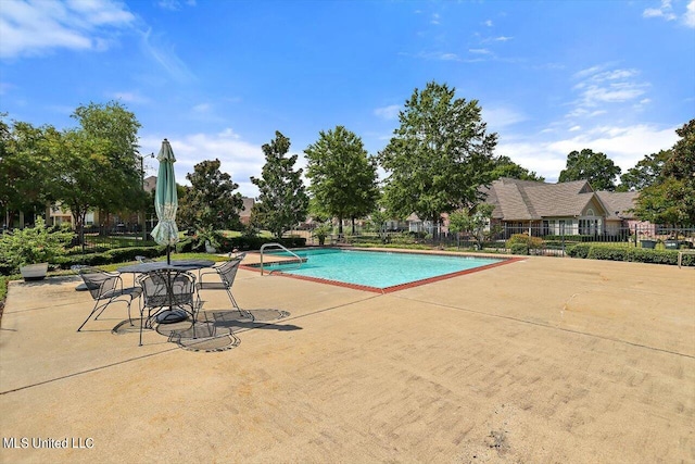 view of swimming pool with a patio area