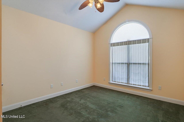 spare room with dark carpet, lofted ceiling, and ceiling fan