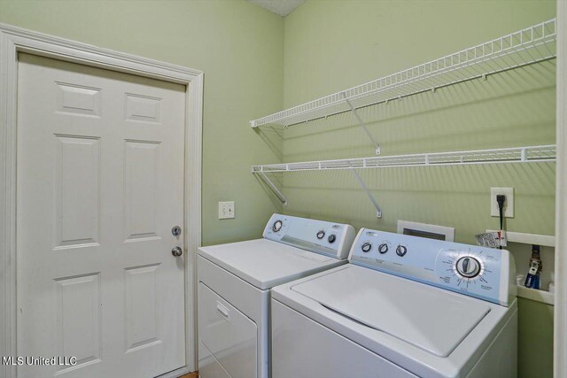 laundry area with washing machine and clothes dryer