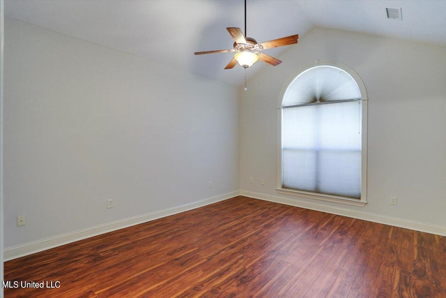 empty room with lofted ceiling, dark wood-type flooring, and ceiling fan