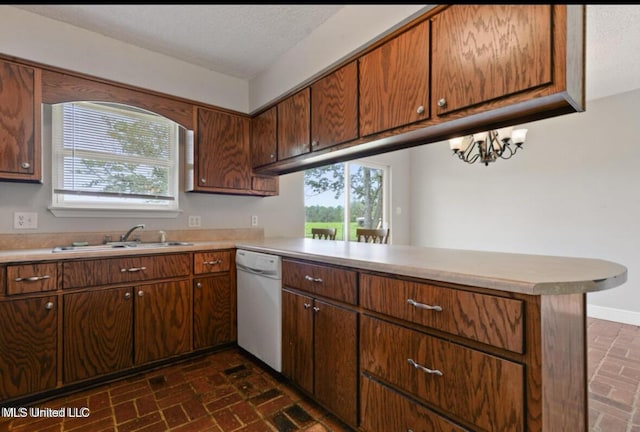 4127 Ceolia Taylor Rd, Moss Point, MS 39562 - kitchen featuring dishwasher, brick floors, a sink, light countertops, and a peninsula