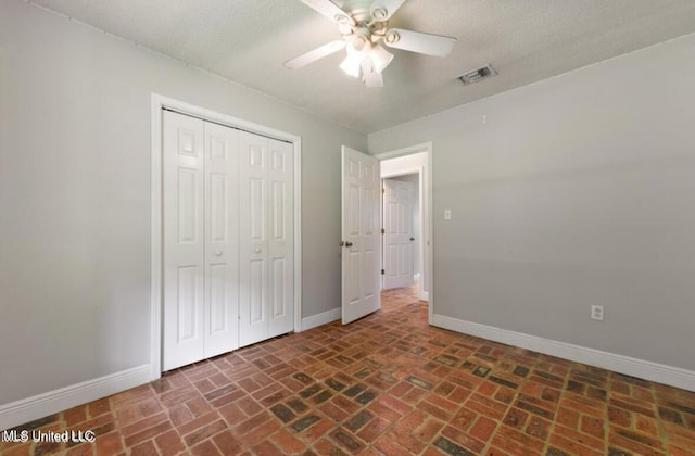 4127 Ceolia Taylor Rd, Moss Point, MS 39562 - unfurnished bedroom with brick floors, baseboards, a closet, and a ceiling fan