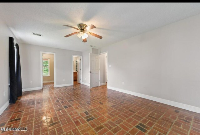 4127 Ceolia Taylor Rd, Moss Point, MS 39562 - unfurnished room featuring brick flooring, ceiling fan, and baseboards