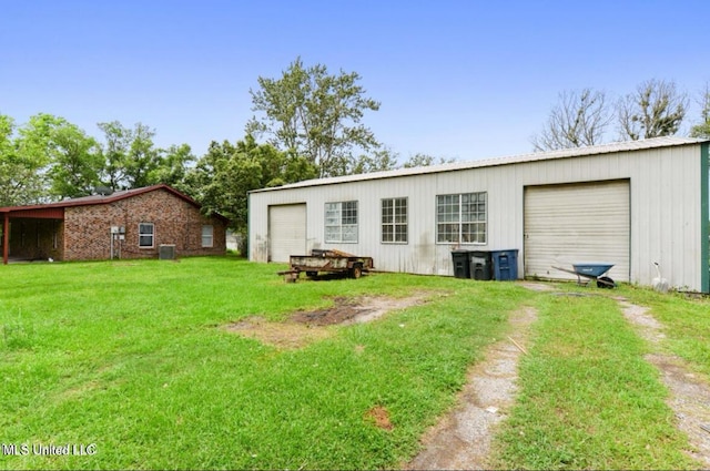 4127 Ceolia Taylor Rd, Moss Point, MS 39562 - rear view of house featuring driveway, an outdoor structure, a yard, and metal roof