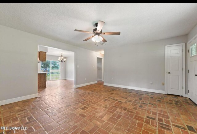 4127 Ceolia Taylor Rd, Moss Point, MS 39562 - spare room featuring a chandelier, a ceiling fan, brick flooring, and baseboards