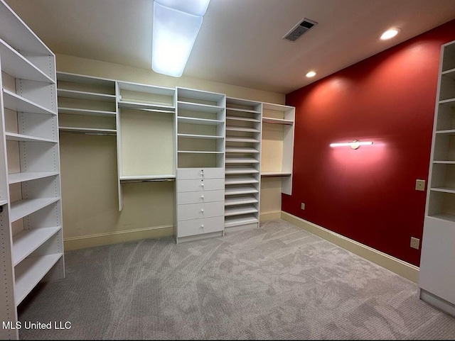 spacious closet featuring visible vents and carpet flooring