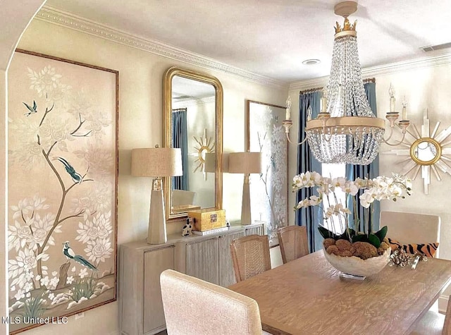 dining space featuring visible vents, ornamental molding, and an inviting chandelier