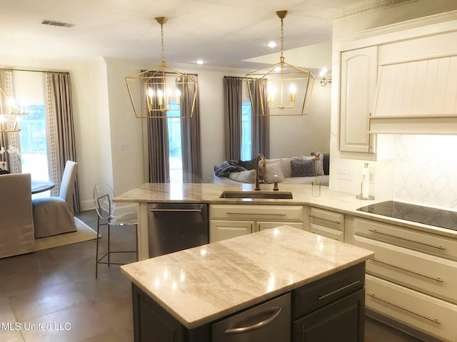 kitchen featuring a peninsula, a sink, visible vents, an inviting chandelier, and white cabinetry